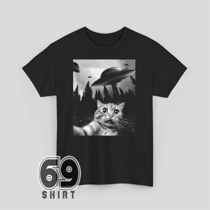 Unisex shirt with funny graphic of scared cat taking selfie as UFO hovers in background – meme-style art.