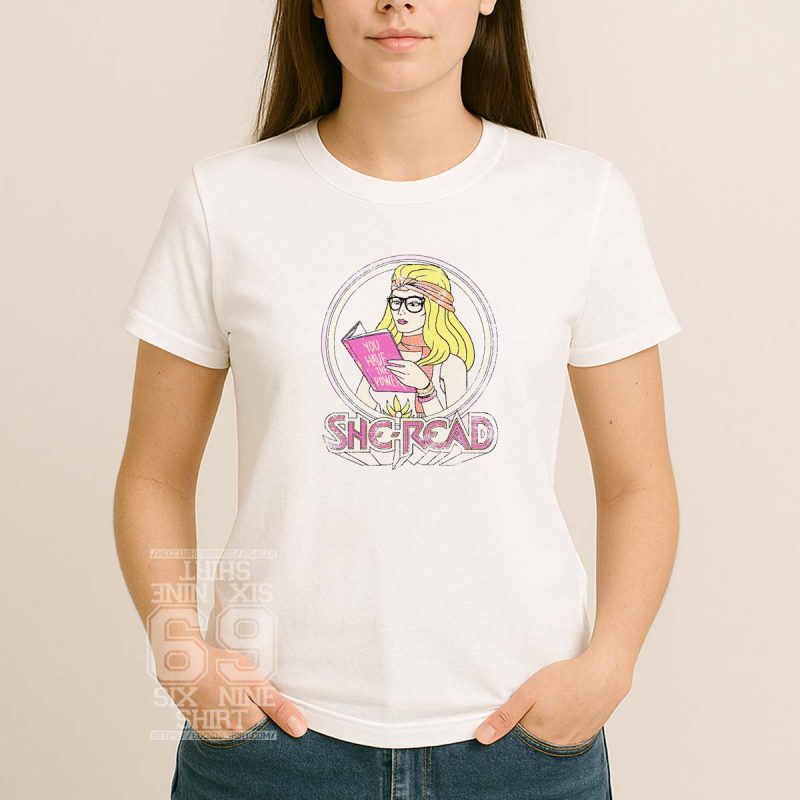Illustrated “She-Read” design of a retro blonde woman reading a book titled “You Have the Power” in pink, feminist and book-themed apparel