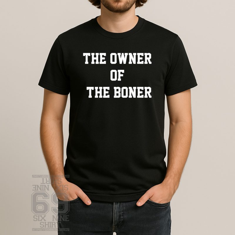 Man wearing a black t-shirt with bold arrows and the text “The Owner of the Boner” in a party bar
