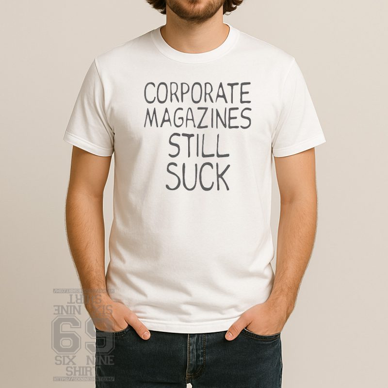 Grunge-style t-shirt with handwritten text that reads “Corporate Magazines Still Suck” in black on a white or faded tee, inspired by Kurt Cobain.