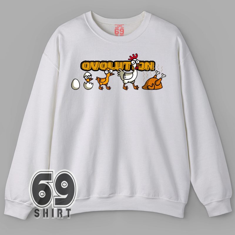 A white t-shirt with a cartoon graphic showing the evolution of a chicken from egg to roasted meat, labeled “OVOLUTION”.