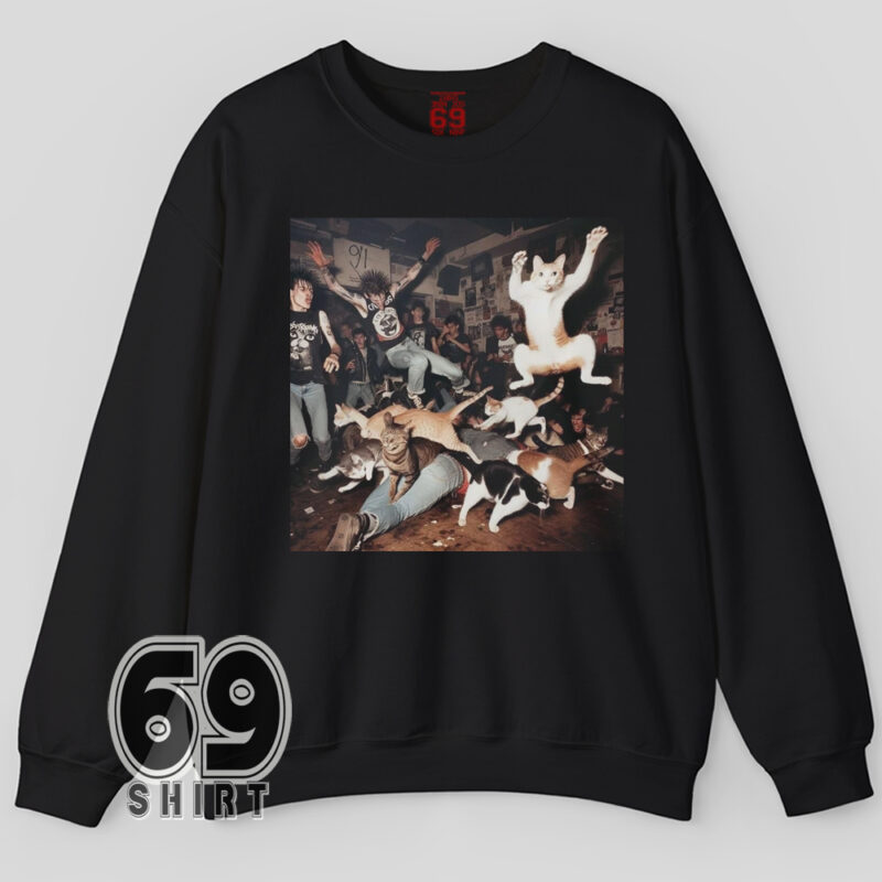 Funny sweatshirt featuring a crowd of energetic punk cats moshing at a concert in a chaotic scene
